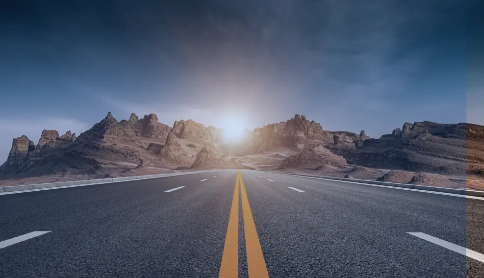 Open highway with mountain scenery at sunrise, symbolizing a clear and unobstructed journey
